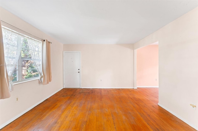 unfurnished room featuring hardwood / wood-style floors