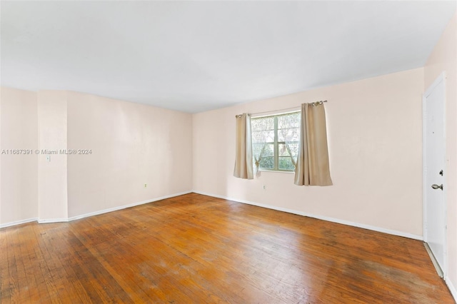 empty room featuring hardwood / wood-style flooring