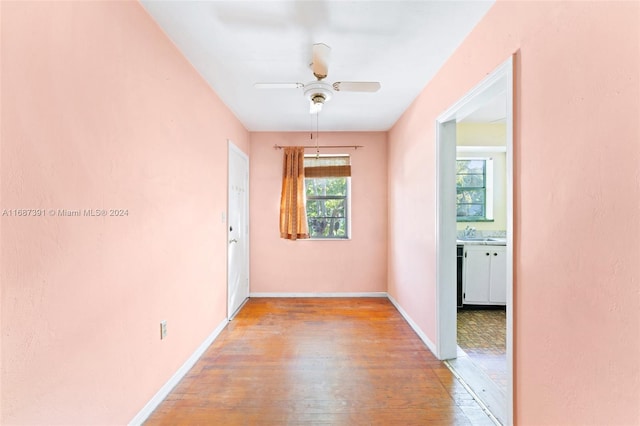 hallway featuring sink and light wood-type flooring