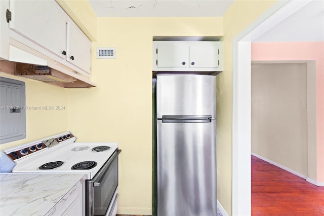 kitchen featuring white electric stove, white cabinetry, stainless steel refrigerator, and dark hardwood / wood-style floors