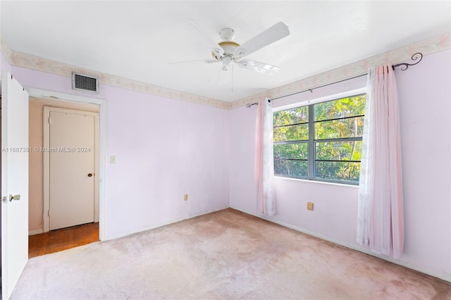 carpeted empty room featuring ceiling fan