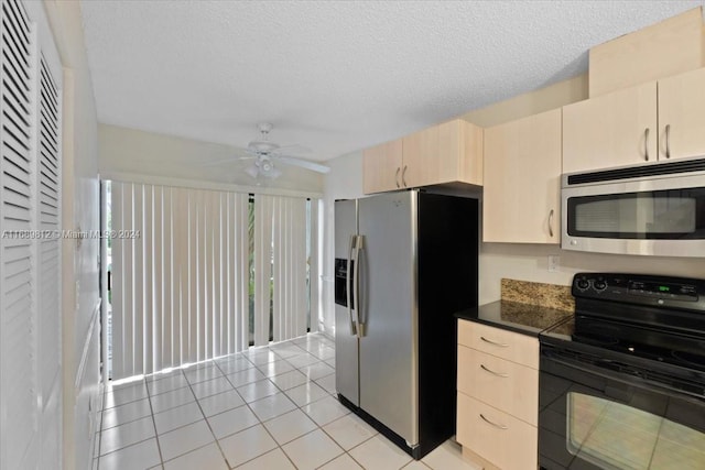 kitchen with a textured ceiling, stainless steel appliances, ceiling fan, and light tile patterned flooring