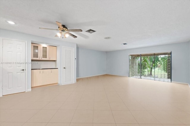 unfurnished room featuring ceiling fan and a textured ceiling