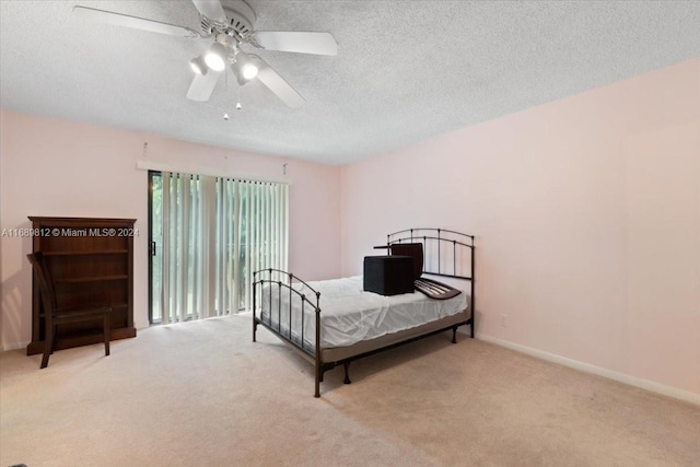 bedroom with light carpet, a textured ceiling, and ceiling fan