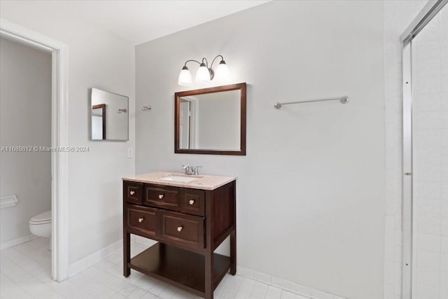 bathroom with a shower, vanity, toilet, and tile patterned flooring