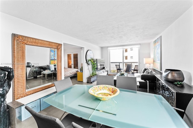 dining area featuring a textured ceiling