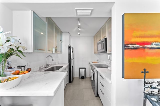 kitchen with sink and appliances with stainless steel finishes