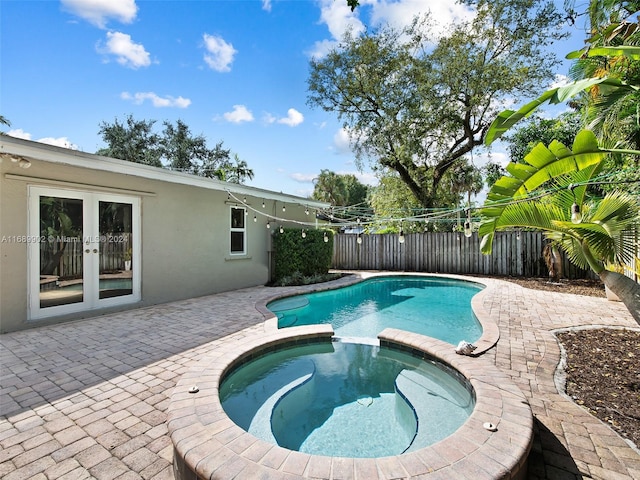 view of pool featuring an in ground hot tub and a patio area