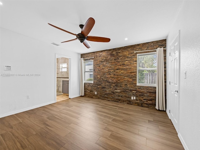 unfurnished bedroom with connected bathroom, ceiling fan, and light hardwood / wood-style flooring