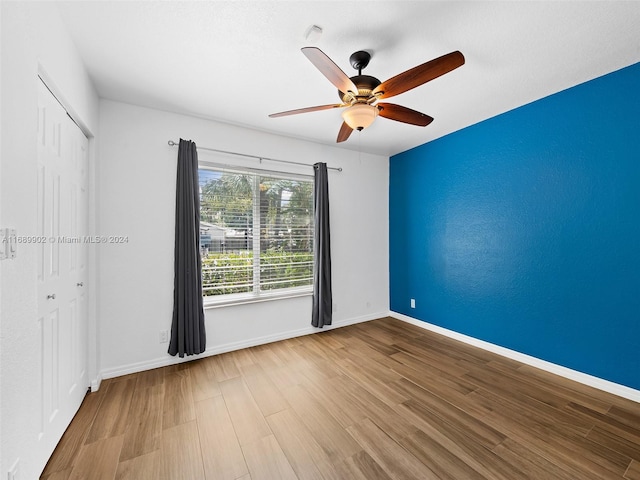 spare room with hardwood / wood-style floors and ceiling fan