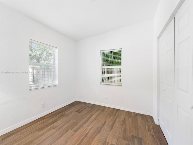 unfurnished bedroom with hardwood / wood-style floors and a closet