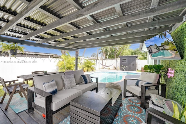 view of patio with a storage unit, a fenced in pool, and an outdoor hangout area