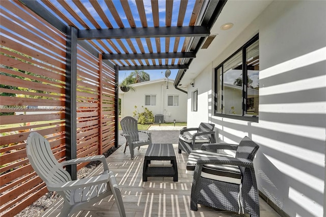 view of patio with central air condition unit and a pergola