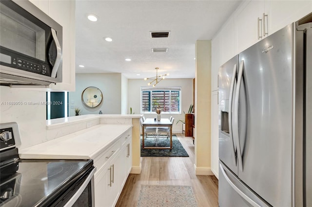 kitchen featuring black range with electric stovetop, stainless steel refrigerator with ice dispenser, a chandelier, white cabinets, and light wood-type flooring