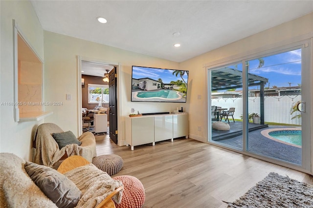 living room with ceiling fan and light hardwood / wood-style floors