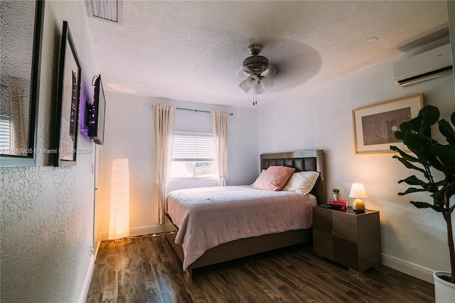 bedroom featuring a wall mounted AC, ceiling fan, dark hardwood / wood-style flooring, and a textured ceiling