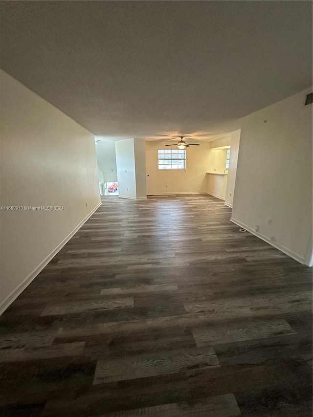 empty room featuring ceiling fan and dark hardwood / wood-style floors