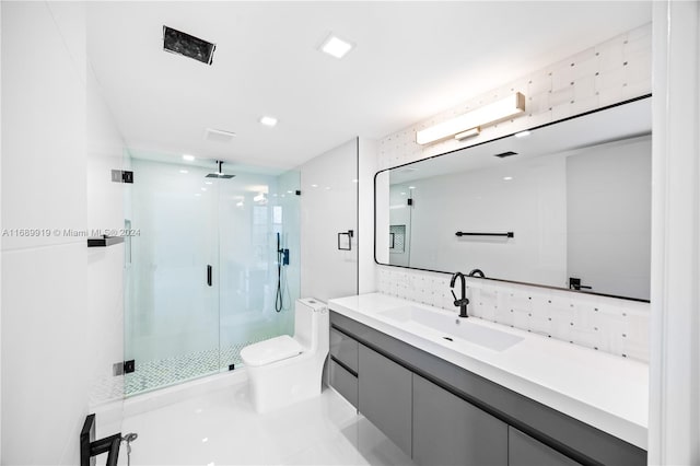 bathroom with an enclosed shower, vanity, toilet, and tile patterned floors