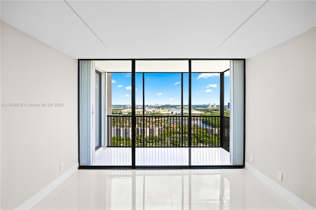 tiled empty room with a wall of windows and a wealth of natural light