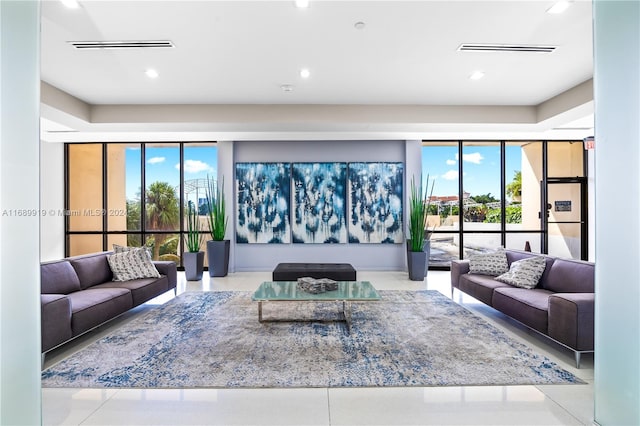 living room featuring light tile patterned floors and a healthy amount of sunlight