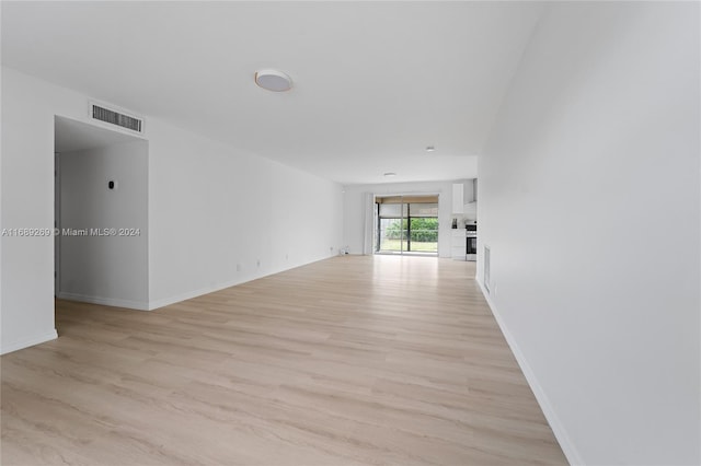 spare room with light hardwood / wood-style floors