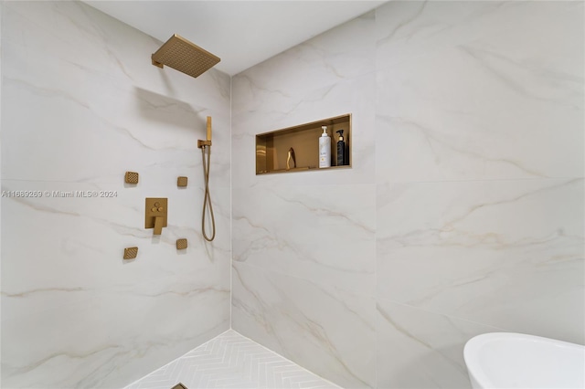 bathroom with a tile shower