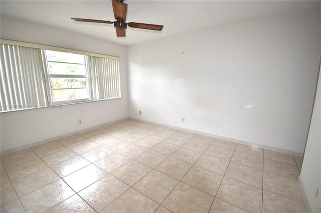 tiled empty room featuring ceiling fan