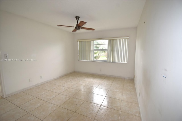 tiled empty room with ceiling fan