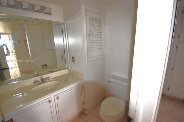 bathroom featuring tile patterned flooring, vanity, and toilet