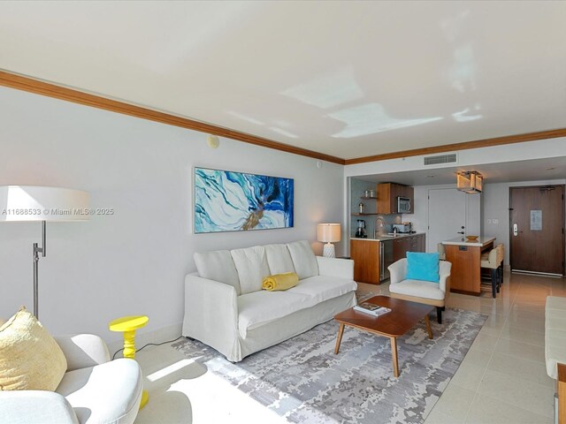 living area featuring visible vents, crown molding, and light tile patterned floors