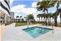 view of swimming pool with a hot tub