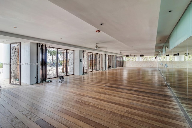 empty room with a ceiling fan and wood-type flooring