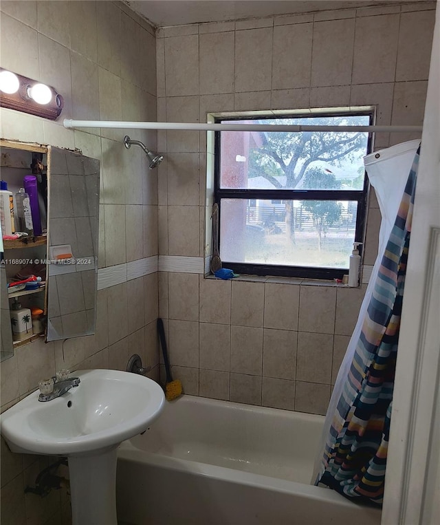 bathroom featuring shower / tub combo and tile walls