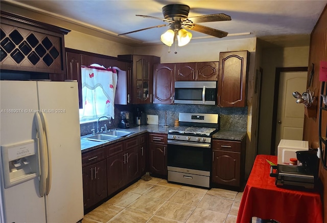 kitchen featuring stainless steel appliances, sink, ceiling fan, and backsplash