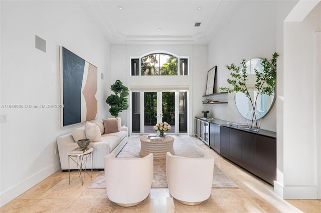 living room featuring a towering ceiling and a tray ceiling