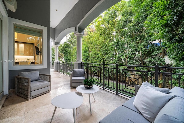 exterior space featuring a balcony and an outdoor living space