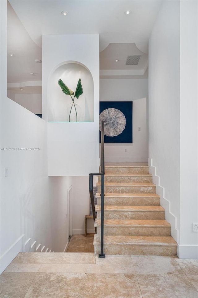 stairs featuring tile patterned flooring