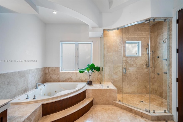 bathroom featuring tile patterned flooring and separate shower and tub