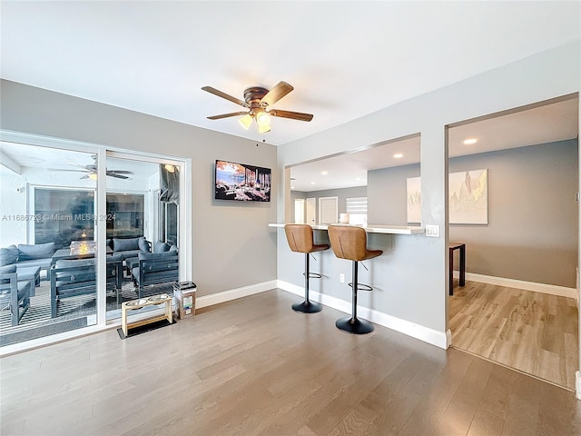 interior space with hardwood / wood-style floors and ceiling fan