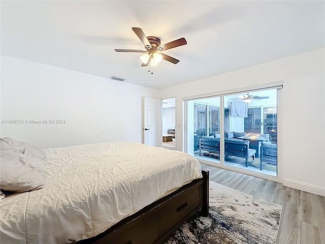 bedroom featuring light hardwood / wood-style floors, ceiling fan, and access to outside