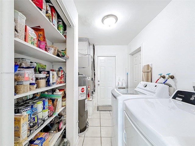 clothes washing area featuring light tile patterned floors and separate washer and dryer