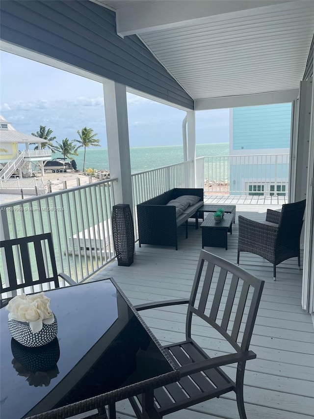 wooden deck featuring an outdoor hangout area and a water view