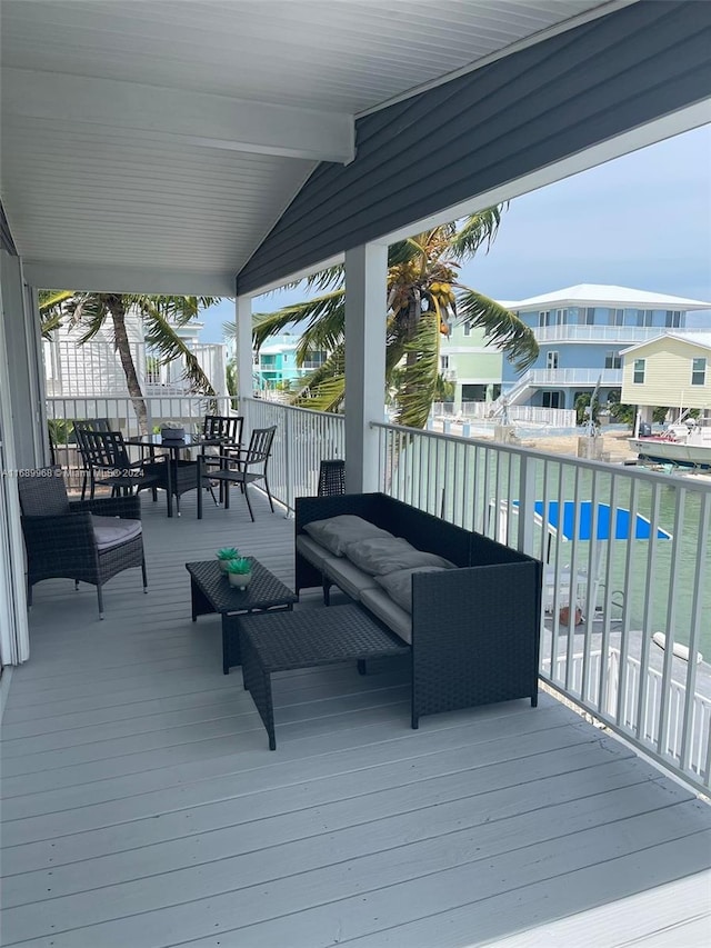 deck with a pool and an outdoor living space