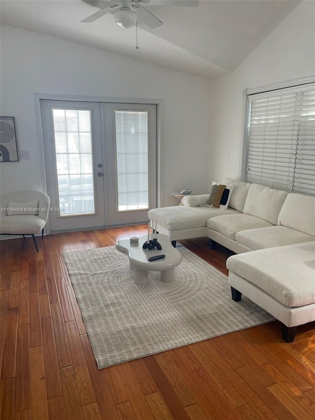 living room with wood-type flooring, vaulted ceiling, ceiling fan, and french doors