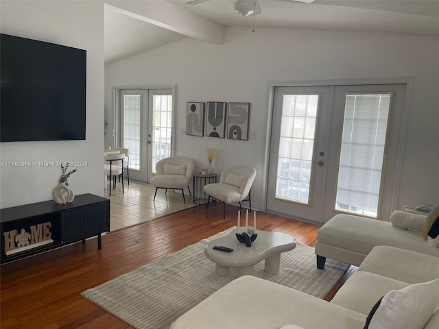 living room with plenty of natural light, french doors, lofted ceiling with beams, and wood-type flooring