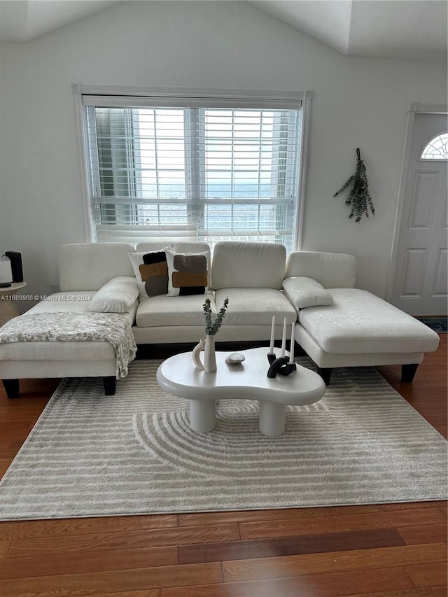 living room featuring hardwood / wood-style flooring and vaulted ceiling