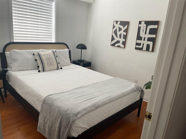 bedroom with hardwood / wood-style floors