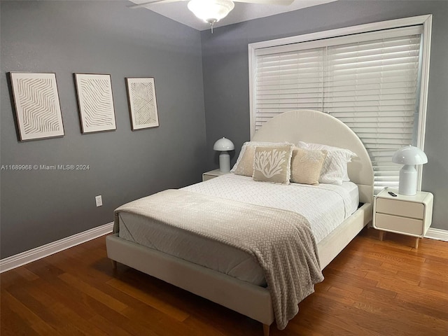 bedroom with dark wood-type flooring and ceiling fan