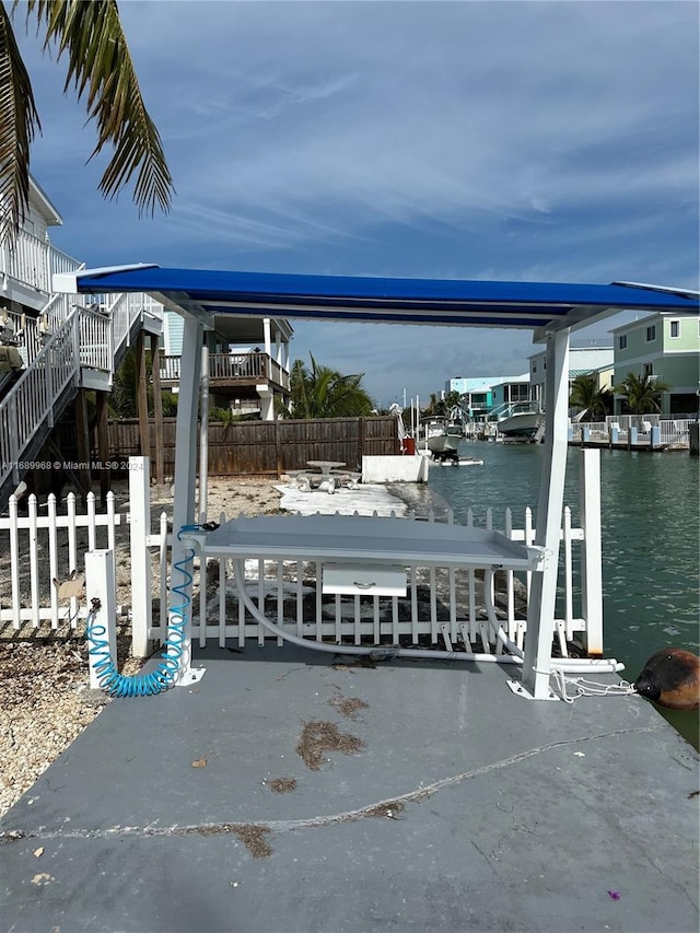 view of patio / terrace with a dock and a water view