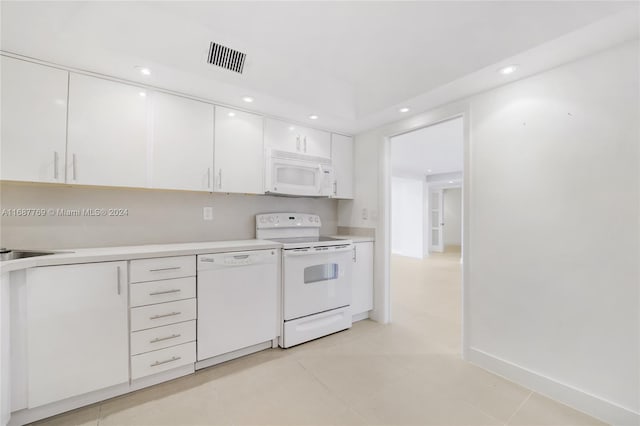 kitchen featuring white cabinetry, white appliances, and light tile patterned floors